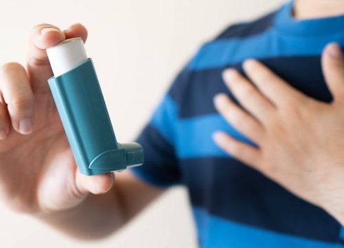 Person holding inhaler while at an Asthma doctor in Fullerton CA