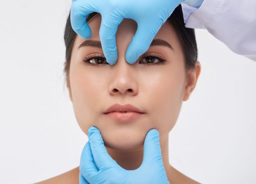 Woman being examined by doctor for a Non-Surgical Rhinoplasty in Fullerton, CA