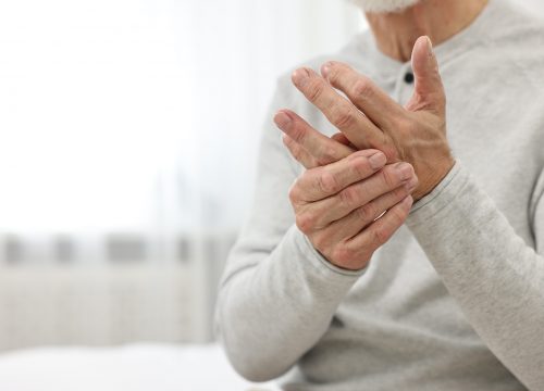 Man holding his hand due to join pain and needing PRP for Joints treatment in Fullerton CA